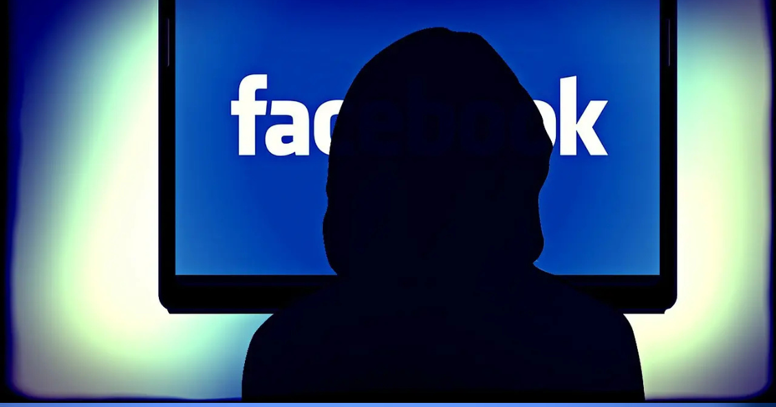 Photo of a person looking at a screen with "Facebook" on it.