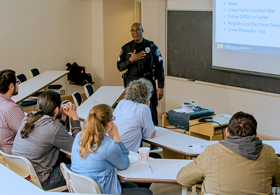 Photo of an officer giving a presentation in a classroom.