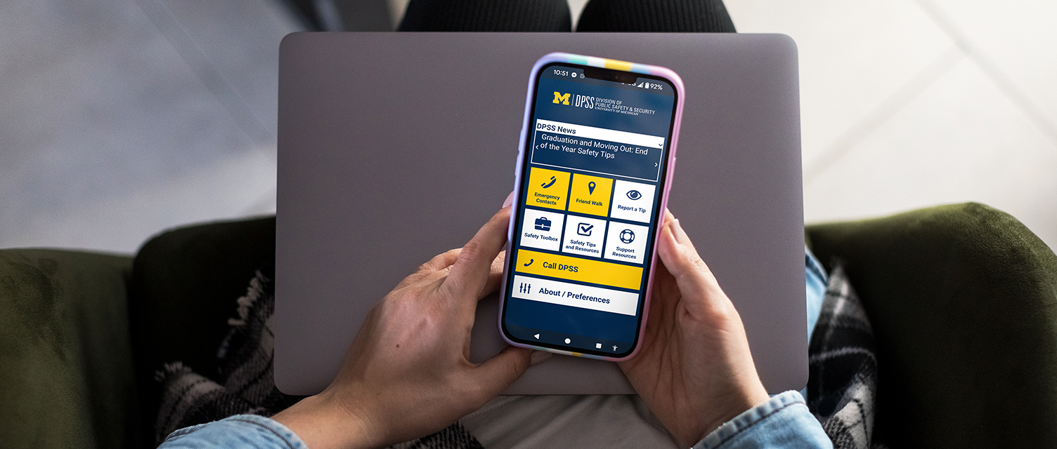 Photo of a person looking at the DPSS App on their phone.