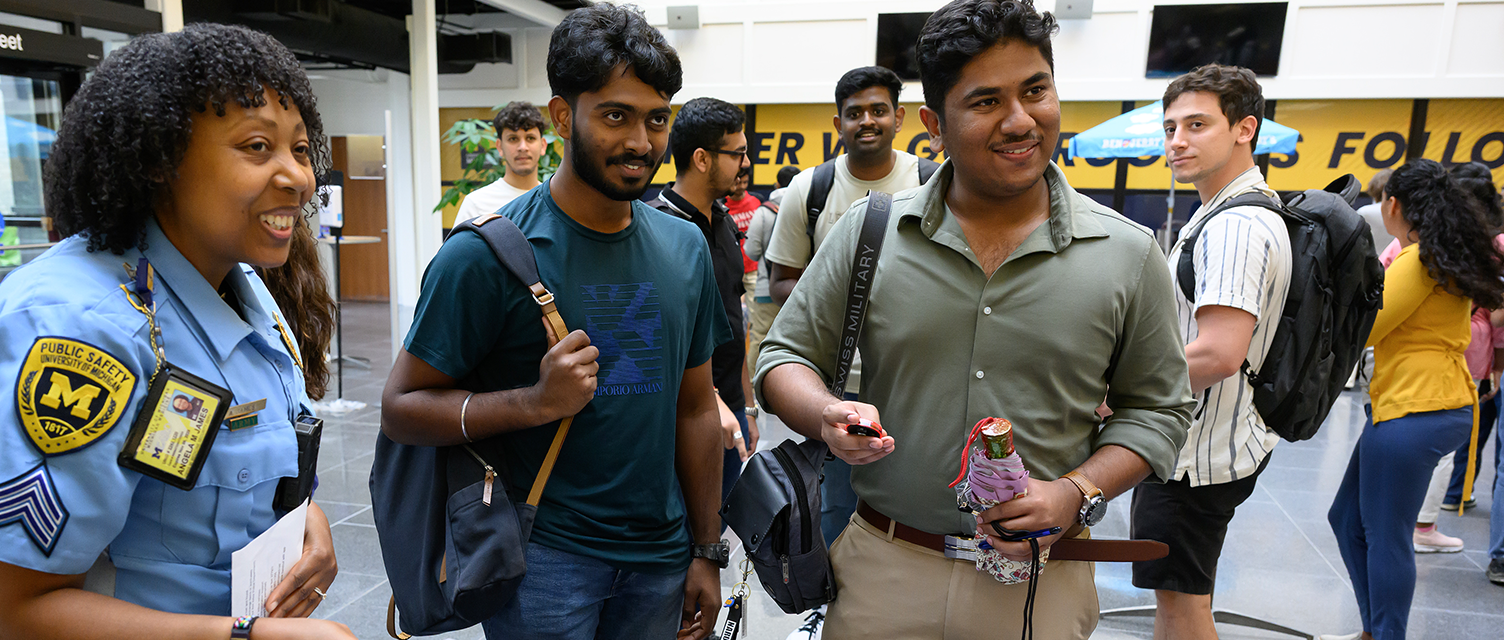 Image of an officer and students smiling.