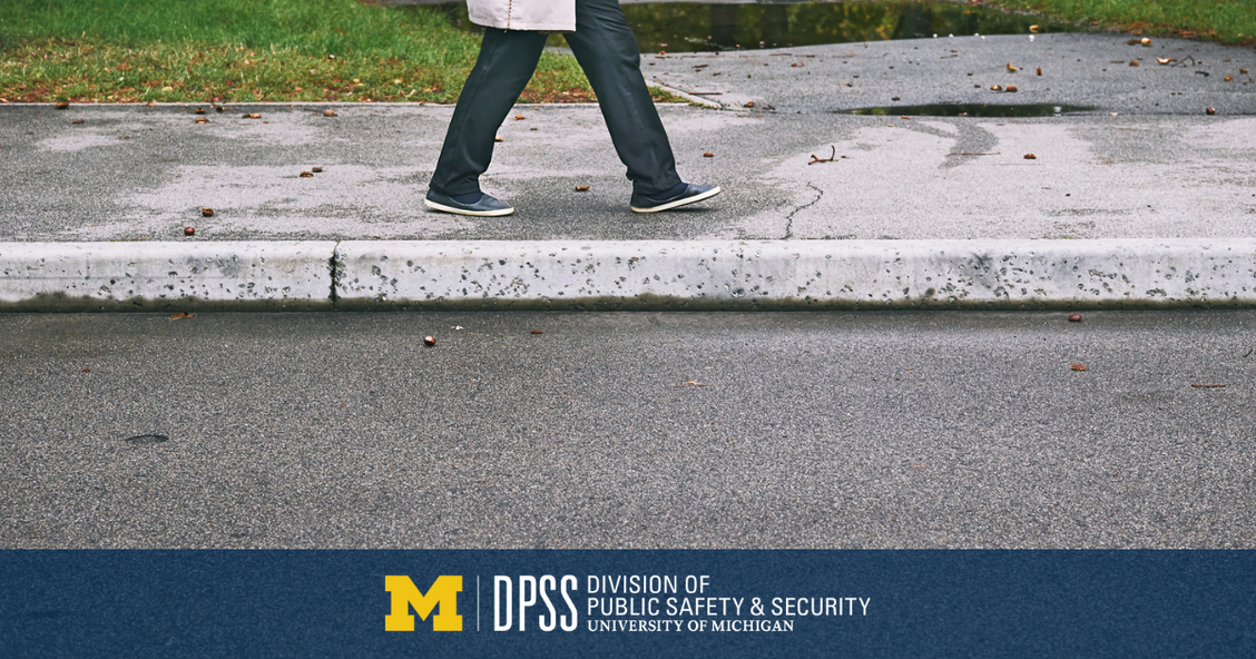 A person walks along a sidewalk.