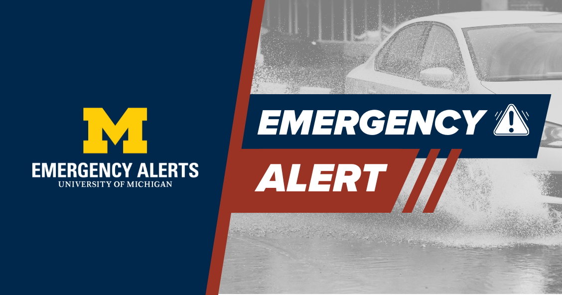 Graphic of a car driving through flooded water with Emergency Alert overlayed.