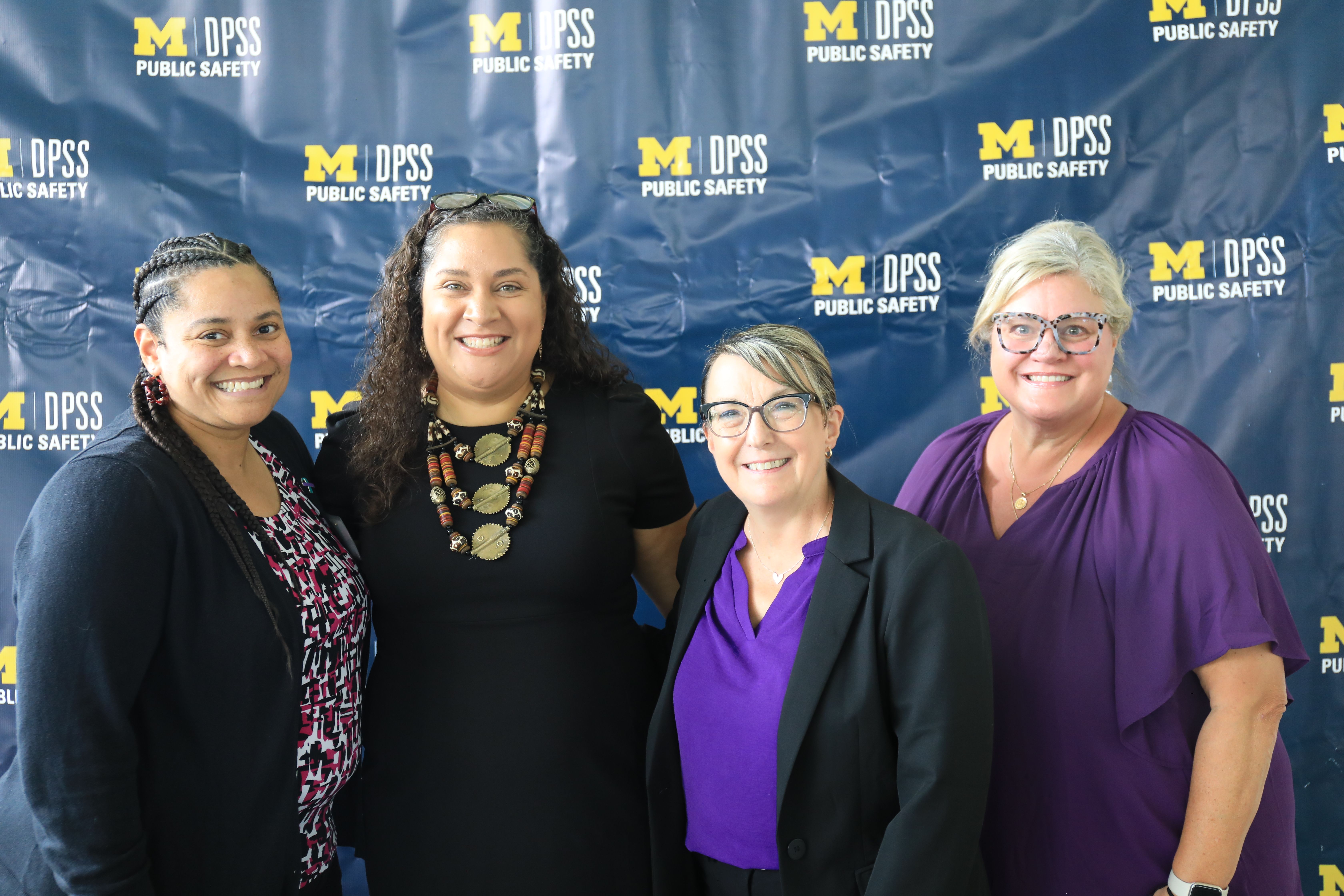 Members of the SVU team stand together, smiling.