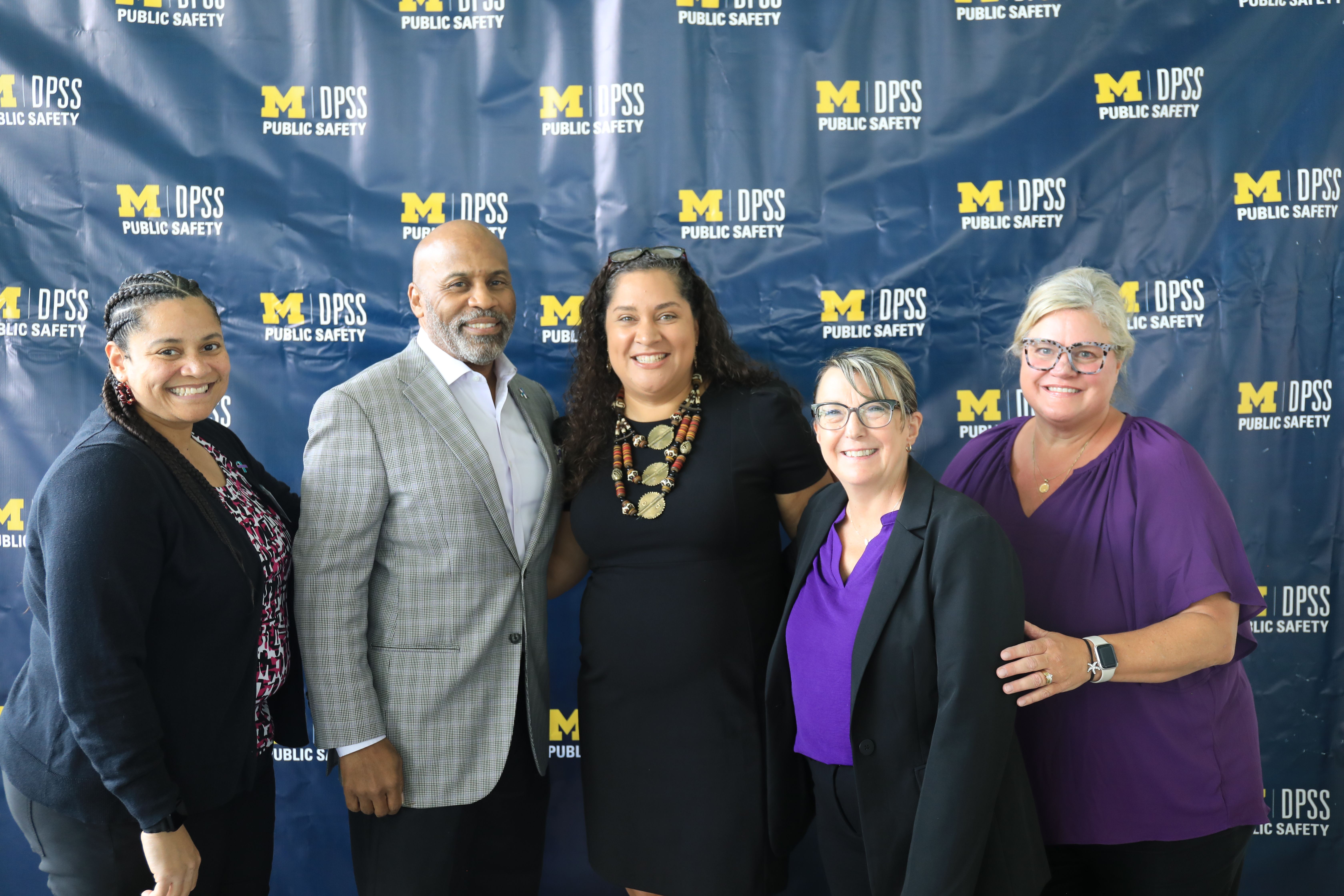 Members of the SVU team stand together, smiling.